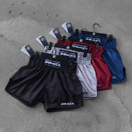 The SIAMKICK Core Series Muay Thai shorts shown together in black, white, maroon and navy