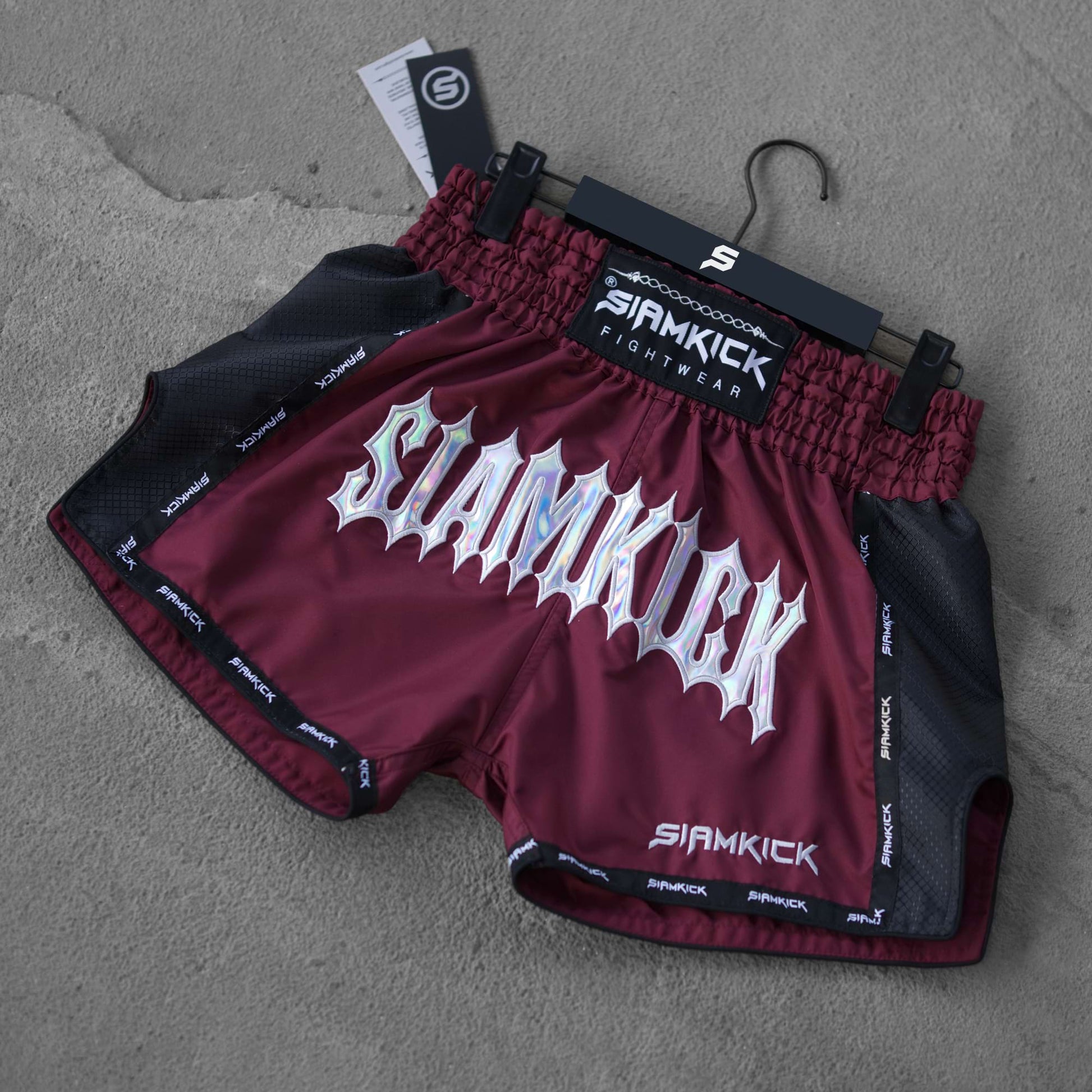 burgundy muay thai shorts on the floor