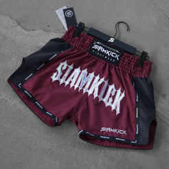 burgundy muay thai shorts on the floor