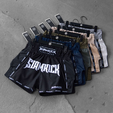 The SIAMKICK Warpath Series Muay Thai shorts shown together in black, navy, green, tan and white
